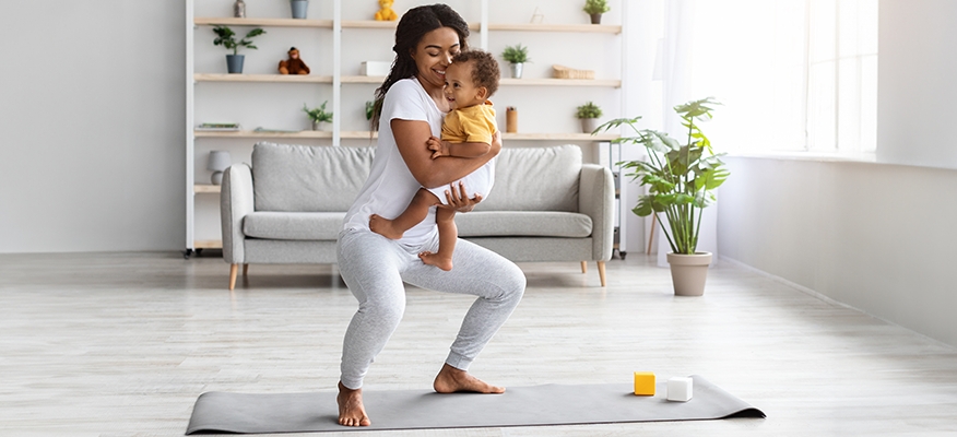 Woman practicing yoga as a postnatal workout for weight loss and well-being